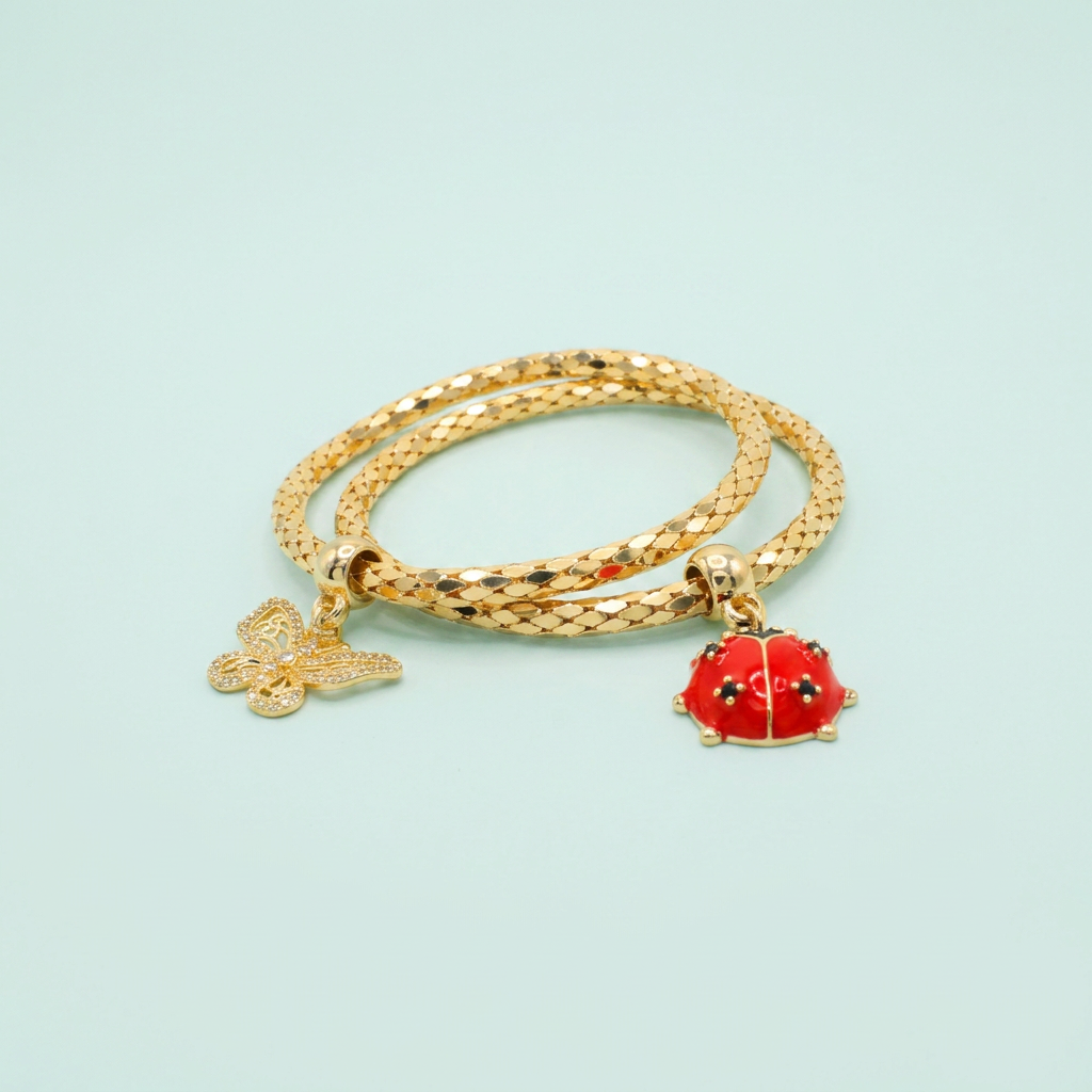 Pulsera de Goldfilled Estilo Tubular Especial Hueco con Colgantes de Primavera mod. 1099