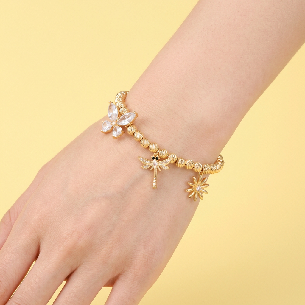 Pulsera Oro Laminado Tejido Esferas Diamantadas con Dijes Primavera mod. 1532